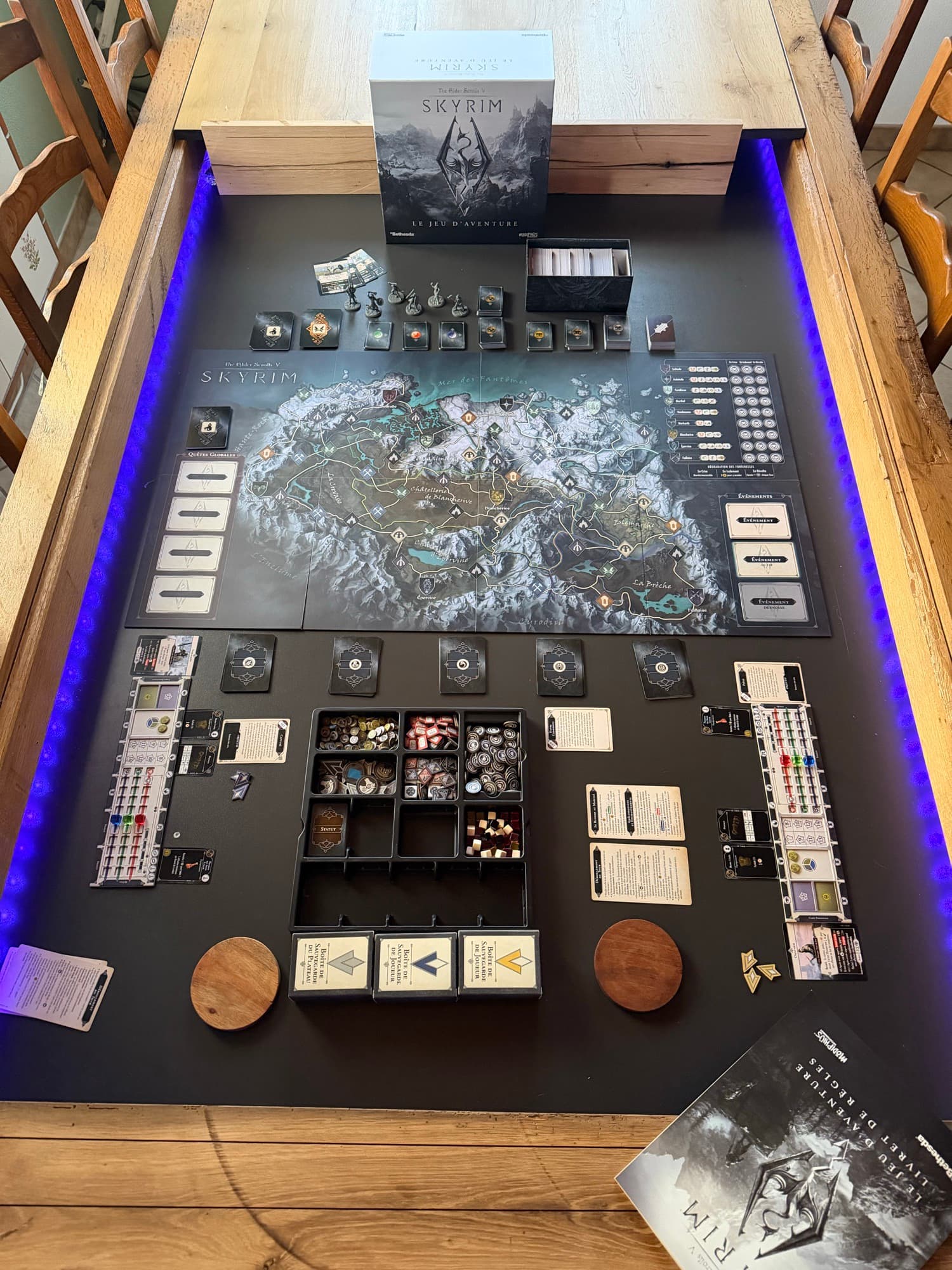 Grand jeu de figurines déployé sur une table de jeu en chêne